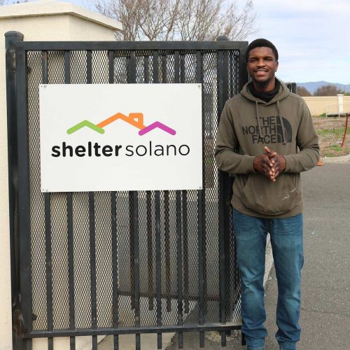 Robert in front of shelter sign Solano